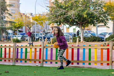 Side view of girl playing with plants