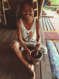 Portrait of smiling young man sitting on chair