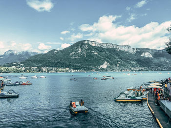 Scenic view of lake between mountains against sky