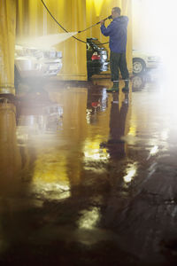 Man washing car in carwash