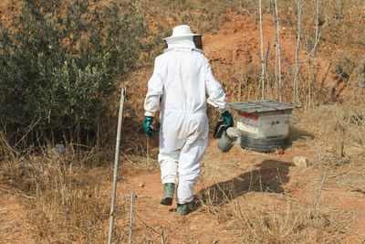 Rear view of man working on grass