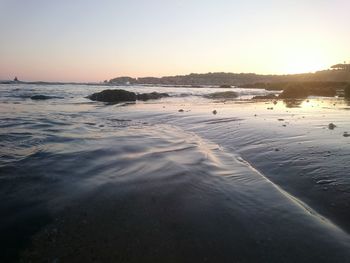 Scenic view of sea against clear sky during sunset