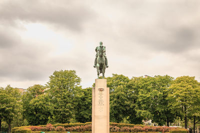 Statue against trees and sky