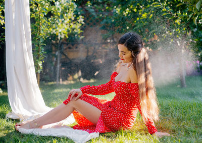 Young woman sitting on field