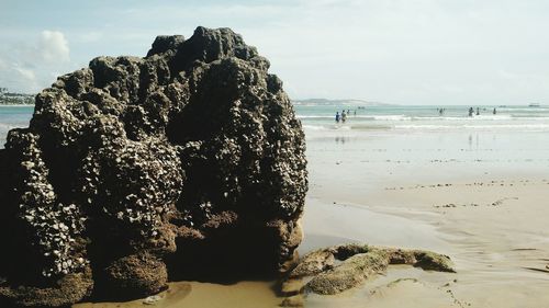 View of rock formation on beach against sky