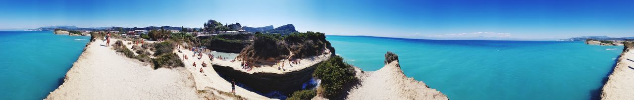 Panoramic view of bay against clear blue sky