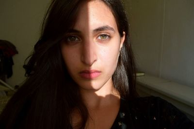 Close-up portrait of young woman at home