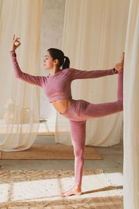 Young woman doing yoga at home