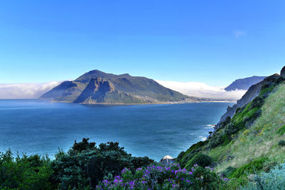 Scenic view of mountains against blue sky