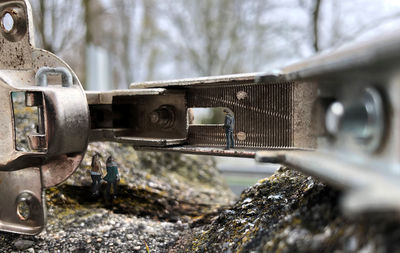 Close-up of old rusty car on field