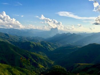 Scenic view of valley and mountains against sky