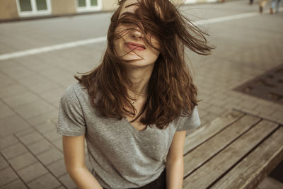 Young woman outdoors with windswept hair