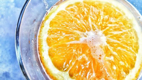 Close-up of orange slice in beer glass