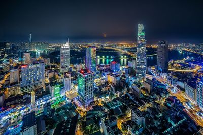 High angle view of illuminated modern buildings in city at night