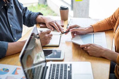 Midsection of business colleagues working at office