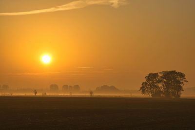 Scenic view of field against sky during sunset