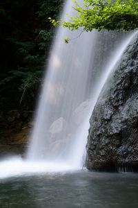 Scenic view of waterfall against sky