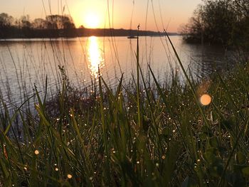 Scenic view of lake at sunset