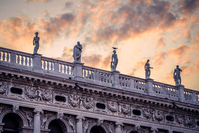 Low angle view of building against cloudy sky