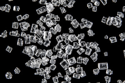 Macro shot of scattered sugar against black background