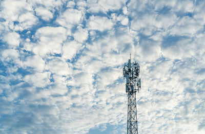 Telecommunication tower with blue sky and white clouds background. antenna on blue sky. radio 