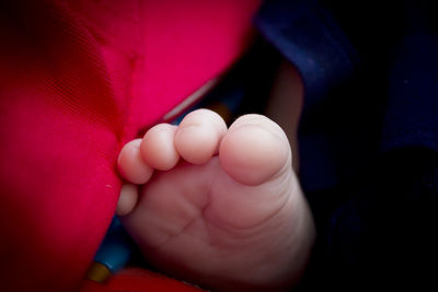 Two month old baby feet on black background. sweet scene