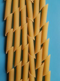 Directly below shot of pasta against blue background
