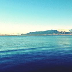 Scenic view of calm sea against clear blue sky