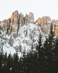 Low angle view of snowcapped mountains against clear sky