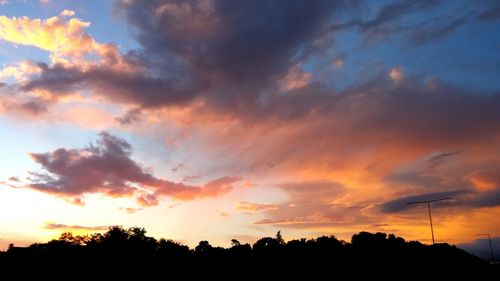 Silhouette of tree against dramatic sky