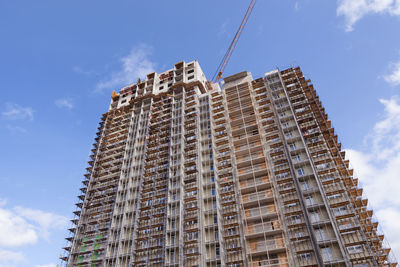 Construction crane building a new high-rise skyscraper or apartment building