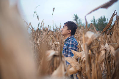 Side view of man standing in farm