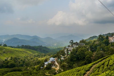 Scenic view of mountains against cloudy sky