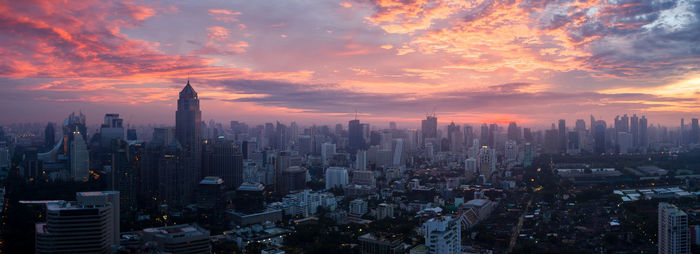 Aerial view of buildings in city during sunset