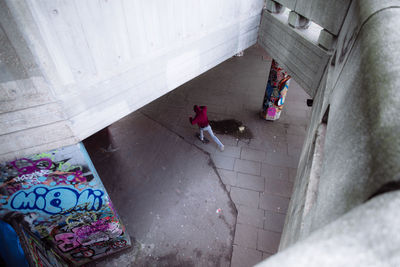 High angle view of man walking on footpath