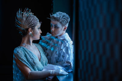 Side view of a young couple looking away