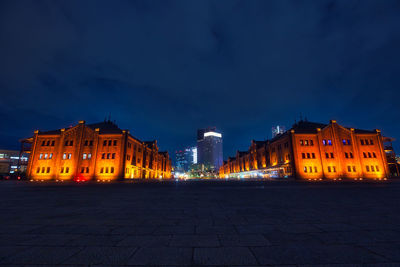 Illuminated building against sky at night