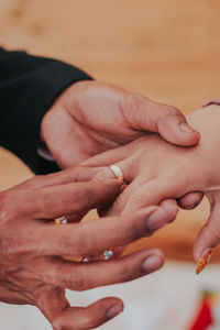 Midsection of couple holding hands