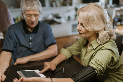 Senior couple taking blood pressure