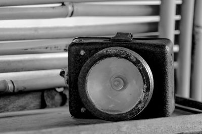 Close-up of old lighting equipment on table