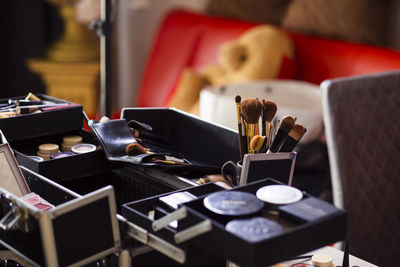 Dedicated focus make-up converter on makeup artist's table with lots of makeup artist tools.
