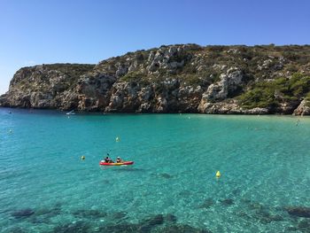 High angle view of two people canoeing in sea