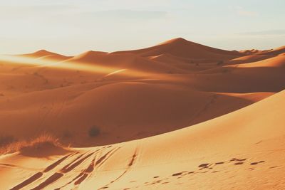 Idyllic shot of sand dunes in desert against sky