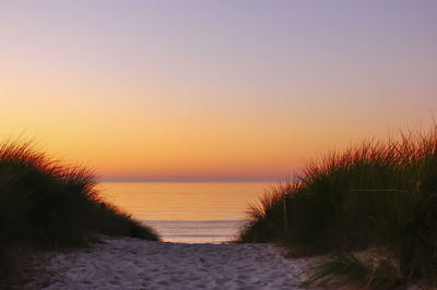 Scenic view of sea against clear sky during sunset