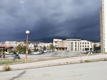 Street by buildings against sky