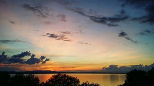 Scenic view of lake at sunset