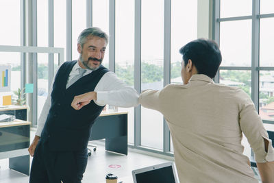 Men standing by window