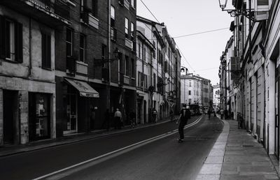 Road amidst buildings in city