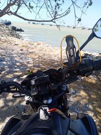 Man riding bicycle on sea shore