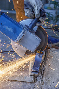 Low angle view of person working on metal